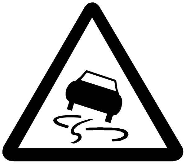 The image shows a black triangle with an exclamation mark inside it containing white text that reads "CAUTION" at its top left corner; within this warning sign is another smaller symbol of a car in motion, indicating caution for moving vehicles.