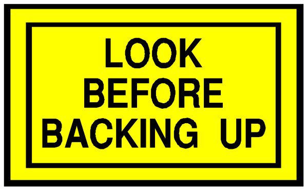 The image shows a yellow caution sign with black text that reads "look before backing up."