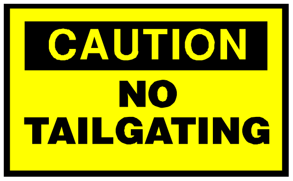 The image shows a caution sign with text that reads "CAUTION NO TAILGATING."
