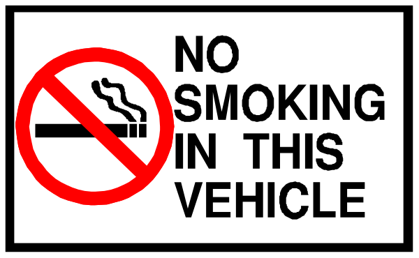 The image shows a sign with text that reads "NO SMOKING IN THIS VEHICLE" at its top half, indicating prohibition of smoking in this vehicle; below it is another smaller white and red rectangular sign stating "SMOKE," which seems to be an instruction or warning.