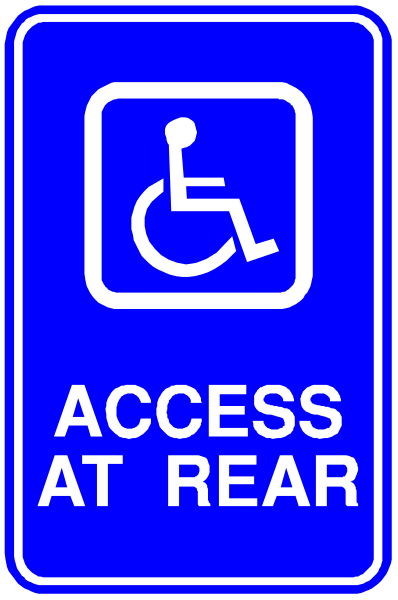The image shows a blue handicap parking sign with white text that reads "ACCESS AT REAR."