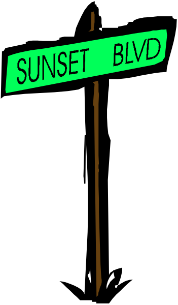 The image shows a black sign with white text that reads "SUNSET BLVD" against a dark background.