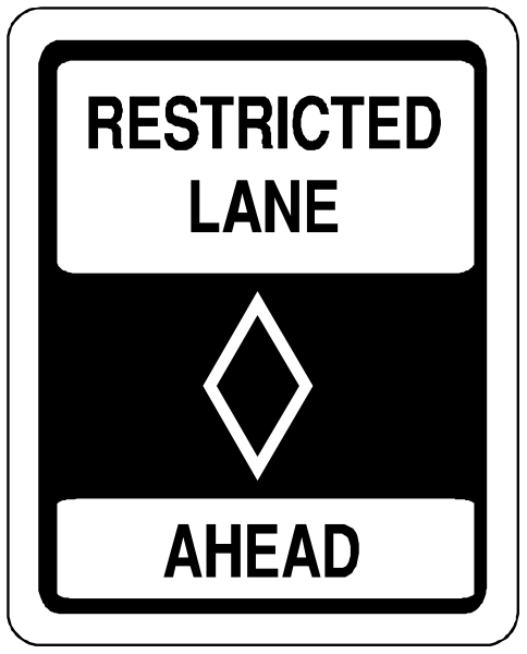 The image shows a black and white sign with text that reads "RESTRICTED LANE AHEAD" at top and bottom of an arrow pointing upwards to indicate caution for restricted lane ahead.