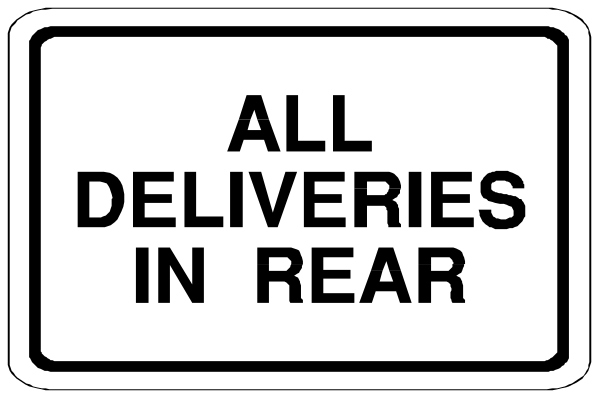 The image shows a black and white sign with text that reads "ALL DELIVERIES IN REAR" on it.