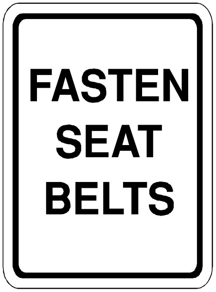 The sign says "FASTEN SEAT BELTS" on a street with no visible cars or pedestrians in sight.