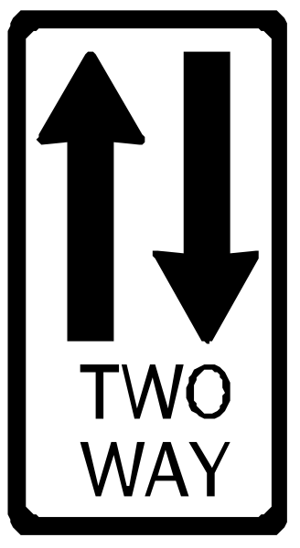 The image shows a black and white traffic sign with an arrow pointing to two directions labeled "two way" on it.