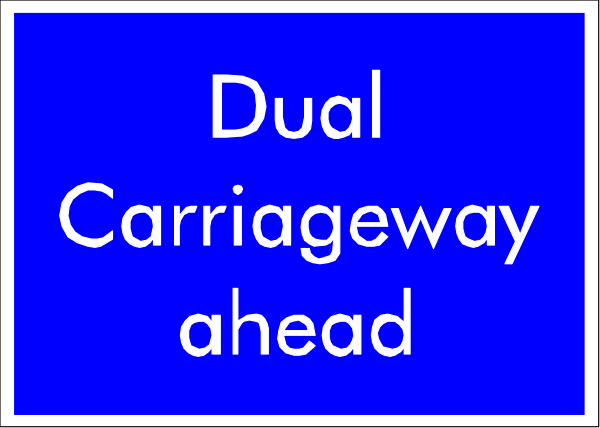The image shows a blue sign with white text that reads "DUAL CARRIAGEWAY AHEAD."