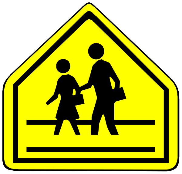 The image shows a yellow school crossing sign with two black silhouettes of adults holding hands walking across it on top; below is another smaller version showing only one adult figure in front of an icon depicting children at play, indicating that there may be kids nearby or presently not visible within the frame.