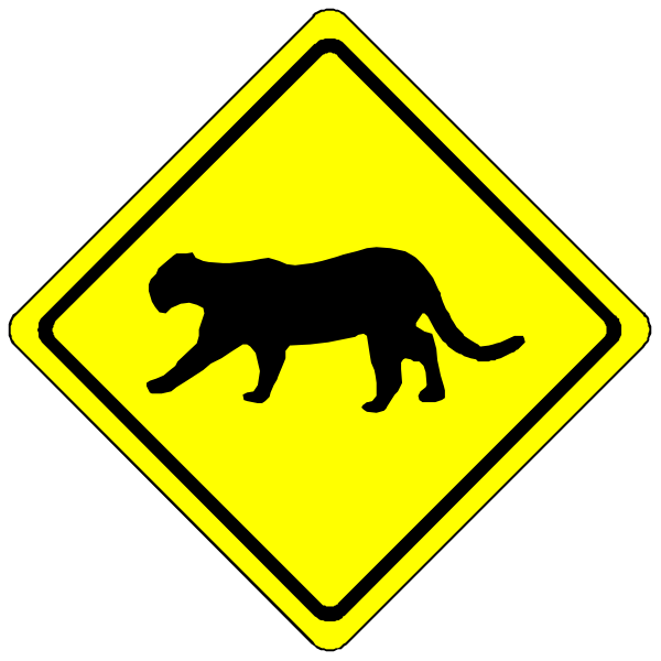 The image shows a yellow road sign with black text indicating an upcoming change to traffic conditions: "CAT CROSSING" on one side of the sign and "WATCH FOR WILDLIFE" on another, suggesting that there is wildlife in this area such as cats crossing roads or walking along them.