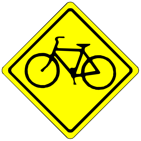 The image shows a yellow diamond sign with black text indicating that bicycles may be present on this roadway; to its right is an icon of a bike in motion next to another smaller white arrow pointing leftward, suggesting caution for cyclists ahead and possibly directing them towards their designated path or area.