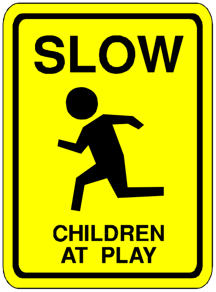 The sign says "SLOW CHILDREN AT PLAY" with a silhouette of a child running on it.