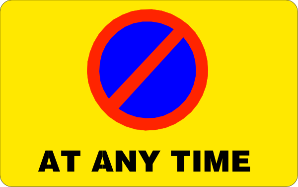 The image shows a sign with text that reads "AT ANY TIME" at its top edge, followed by an icon of a blue circle inside which is depicted a red line through it to indicate prohibition, below this symbol there's another smaller circular graphic showing two crossed-out arrows pointing in opposite directions.