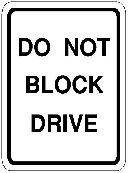 The sign says "do not block drive" on a street corner with no visible surroundings.