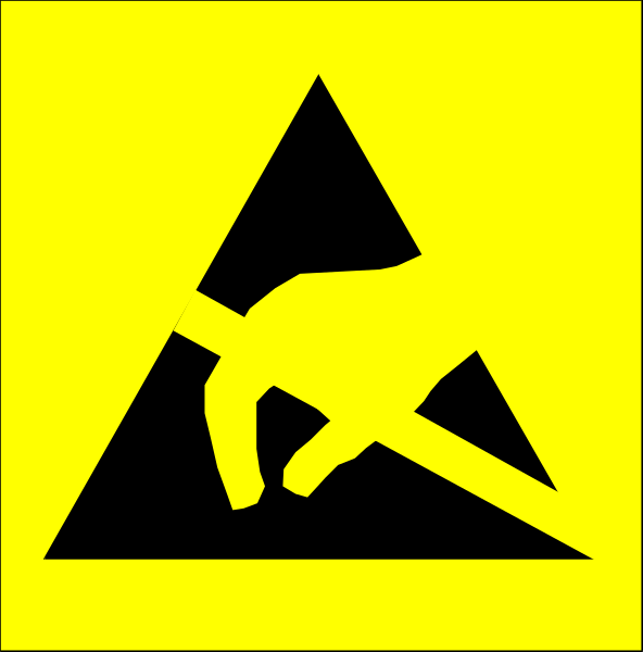 The image shows a yellow hazard sign with an icon of someone falling over on it next to another similar but smaller black-and-white symbol that also depicts tripping danger.