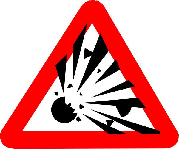 The image shows a red triangular sign with an explosion graphic on it against a black background.