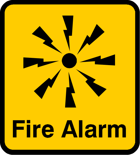 The image shows a yellow sign with black text that reads "FIRE ALARM" inside an orange circle on top of it.