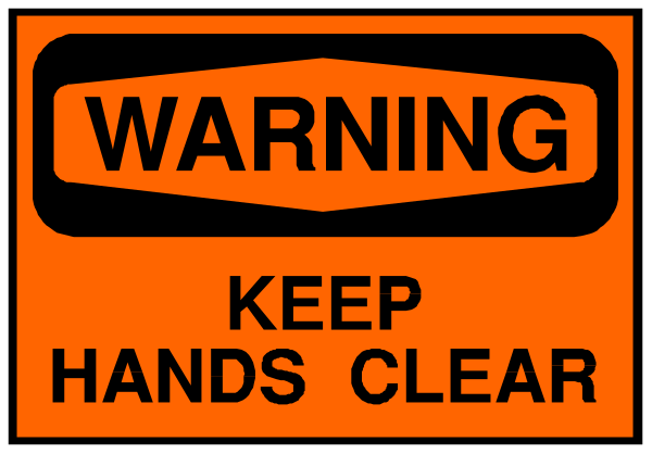 The image shows a warning sign with text that reads "WARNING KEEP HANDS CLEAR" on an orange background within a black border.