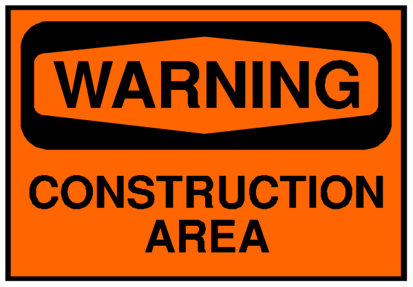 The image shows a warning sign with orange text on it that reads "WARNING CONSTRUCTION AREA."