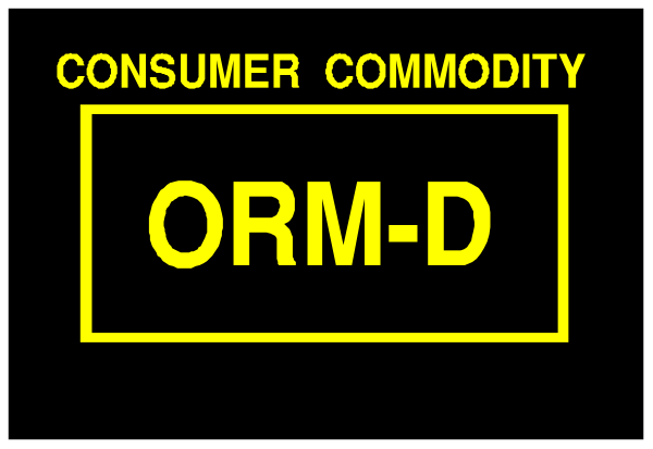 The image shows a yellow sign with black text that reads "CONSUMER COMMODITY" at top left corner followed by an acronym OCRM-D in bold letters on a dark background, indicating it is related to consumer commodity and possibly some form of organization or certification mark.