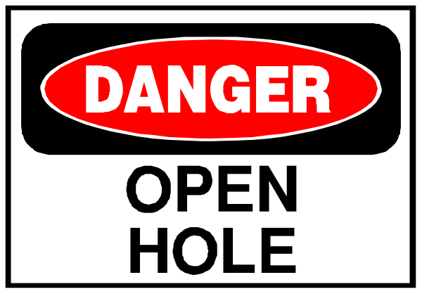 The image shows a sign with text that reads "DANGER OPEN HOLE" on it.