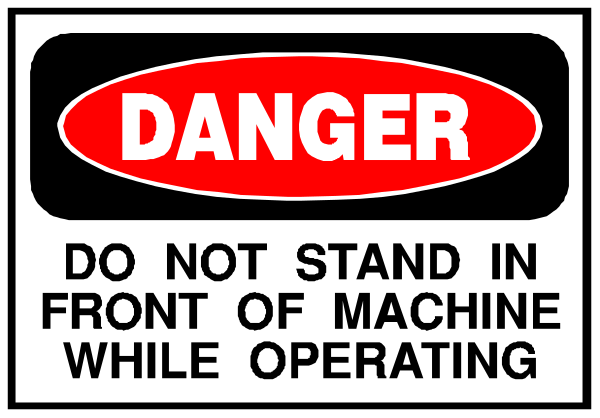 The image shows a sign with text that reads "DANGER DO NOT STAND IN FRONT OF MACHINE WHILE OPERATING."