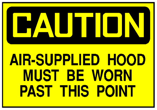 The image shows a caution sign with text that reads "CAUTION AIR SUPPLIED HOOD MUST BE WORN PAST THIS POINT."