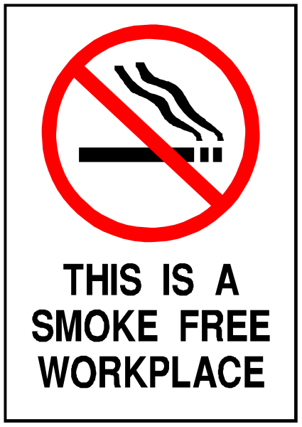 The sign says "This Is A Smoke Free Workplace" with a red circle around it indicating prohibition of smoking in that area.