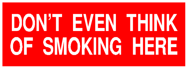 The image shows a sign with text that reads "DON'T EVER THINK OF SMOKING HERE" in bold red letters against an orange background atop what appears to be a gray surface, possibly indicating restricted smoking area rules within a building or establishment.