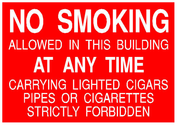 The image shows a red sign with white text that reads "NO SMOKING" at top followed by additional instructions below stating "ALLOWED IN THIS BUILDING AT ANY TIME," listing items such as cigarettes, pipes and tobacco products allowed but not lighted or carried in the building.