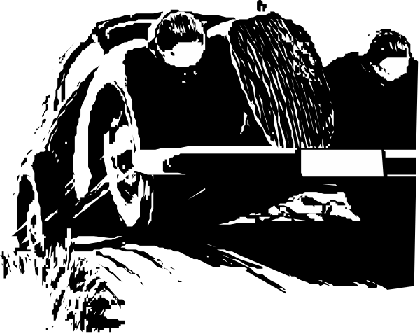 The black and white photo shows a person sitting at an organ with their hands on it; there is another individual standing behind them who appears to be conducting music for this performer.
