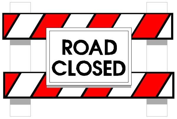 The image shows a red road closed sign with white lettering on it against an indistinct background that appears to be grayish in color.