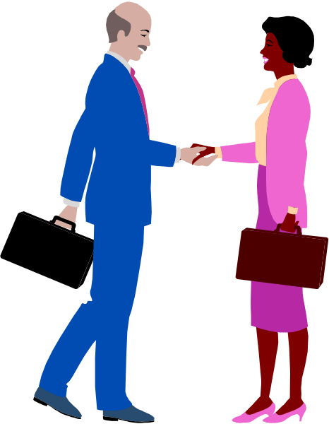 The image shows a man wearing blue suit with pink tie shaking hands with another person who is also dressed professionally but whose gender cannot be determined from this angle. They appear to be in an office environment as suggested by their attire and setting, which includes what looks like a desk or table on the right side of the frame.