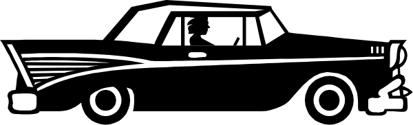 The black and white photo shows a classic car with an elongated body design parked next to another similar vehicle on what appears to be a street at nighttime.