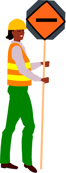 The image shows a construction worker standing next to an orange traffic sign on top of a pole with black stripes at nighttime in front of what appears to be a road under repair.