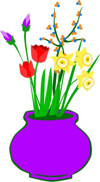 The image shows a vase filled with colorful flowers placed on top of what appears to be an old-fashioned stovepipe oven door in front of which there is a window displaying various items including tulips, daffodils and other spring bulbs.