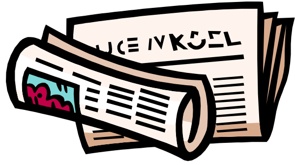 The image shows a newspaper with black text on white paper lying flat against what appears to be an inclined surface; there is no visible content in the newspaper's pages due to its angle of view from above.