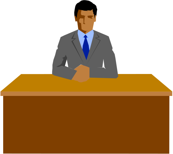 The image shows a pixelated representation of an animated character sitting at a desk with his hands clasped together on top of it in front of him. He is wearing a suit jacket over what appears to be a blue shirt, and he has short hair that's darker than his skin tone. Behind the man are two other characters; one stands behind another chair facing away from us while also dressed formally with a tie visible under their clothing. The setting suggests an office environment due to the presence of desks and chairs in what looks like a meeting room or conference area, indicated by the patterned