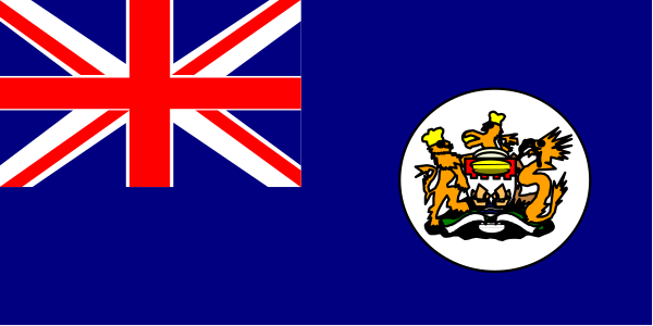 The flag of New Zealand with a British Union Jack on it flying next to another unidentified blue flag featuring an emblem in white at its center.
