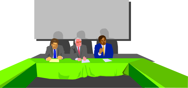 The image shows a cartoon of three men sitting at a table with microphones on it; there is also an audience in front of them who appear to be listening attentively.
