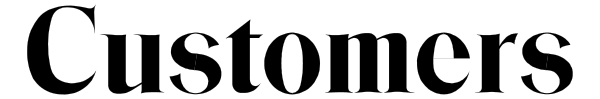 The image shows a black cat sitting on top of an orange table with white legs.