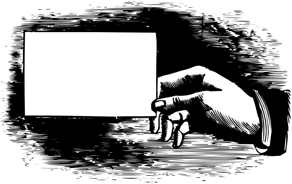 The black and white photo shows a person holding up an empty picture frame with their left hand while standing next to it on what appears to be a stage set against a dark background.