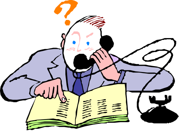 The cartoon shows a man sitting at his desk with an open book on it, looking puzzled as he holds up a finger to ponder something.