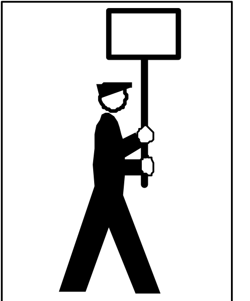 The image shows a black and white silhouette of an individual holding up a sign with their left hand while standing on top of another person's shoulders who is also carrying a protest banner in both hands, suggesting activism or demonstration taking place at nighttime under streetlights.