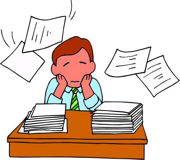 The cartoon shows two men sitting at a desk with papers flying around them; both appear stressed as indicated by their postures and facial expressions.