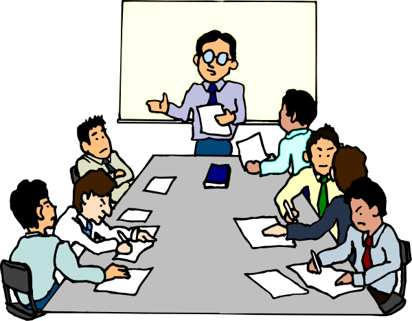 The cartoon shows a group of business professionals sitting around a conference table with papers on it; there is an animated man standing at one end gesturing to them while holding documents in his hands.