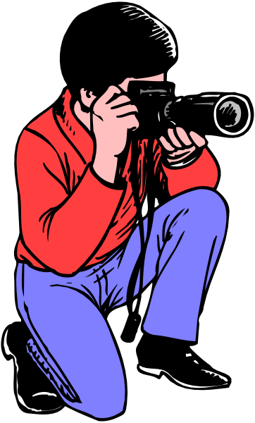 The image shows a man crouching down with an old camera taking pictures of something outdoors during daylight hours.