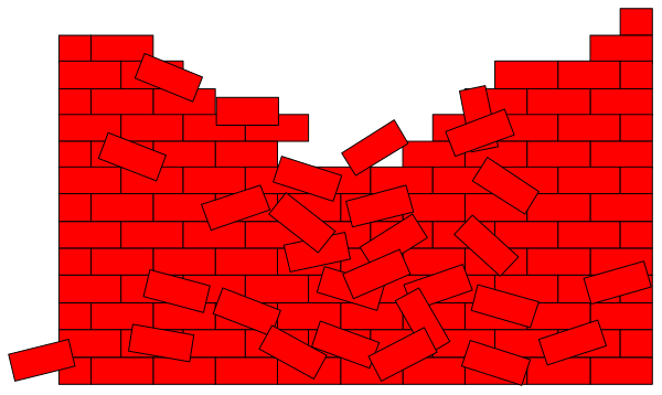 The image shows a brick wall with red bricks that have been knocked out to create an opening on top of which there is rubble scattered around in shades of gray and black.