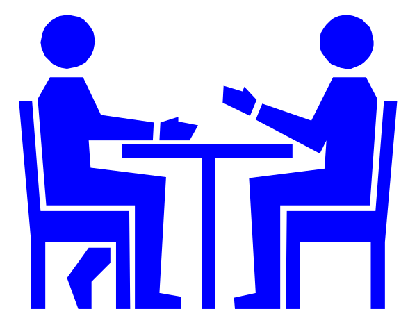 The image shows a black and white illustration of two silhouetted figures sitting at a table with papers on it; one figure appears to be reading while seated in front of another who is standing behind them, both facing each other as if engaged in conversation or negotiation.