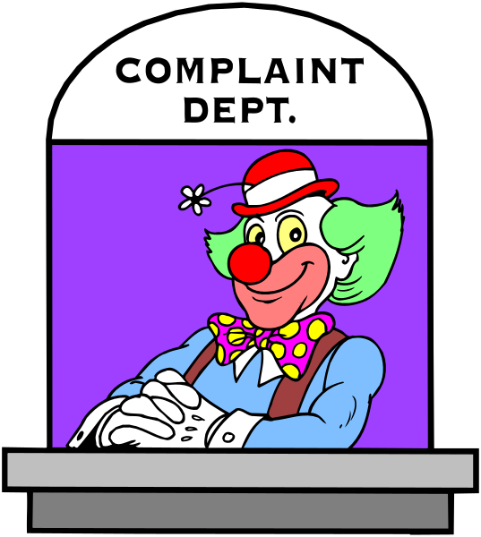 The image shows a cartoon of an animated character resembling Ronald McDonald standing behind a counter with his hands on it in front of him. He is wearing red shorts, white shoes, yellow gloves, and has clown makeup including exaggerated eyebrows and lips painted purple. Above the counter there's sign that reads "COMPLAINT DEPT." The background color appears to be dark blue or black.