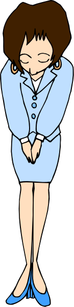 The image shows a woman standing with her hands clasped together over her chest; she is wearing blue pantsuit, heels, earrings, and has short hair.